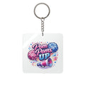 Keychain with 'Pom Poms Up' design featuring pom-poms and a megaphone on a white background